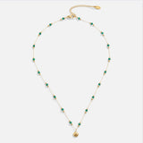 Nerissa arany nyaklánc kagylóval és zöld dekoratív részletekkel